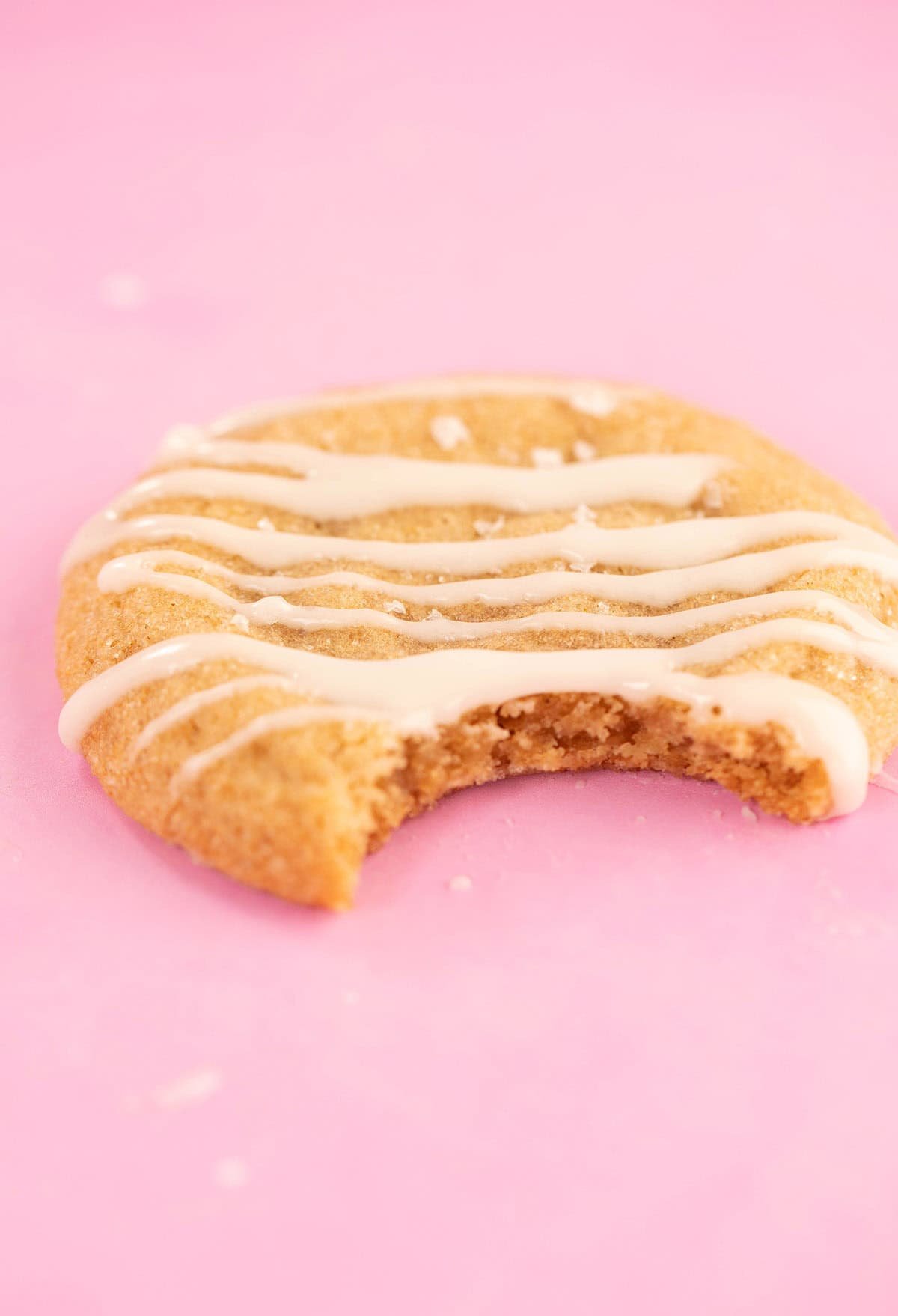 A close up of a soft and chewy gingerbread cookie with a bite taken out of it.