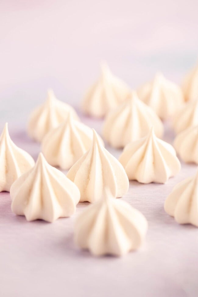 Mini meringue kisses on a purple backdrop
