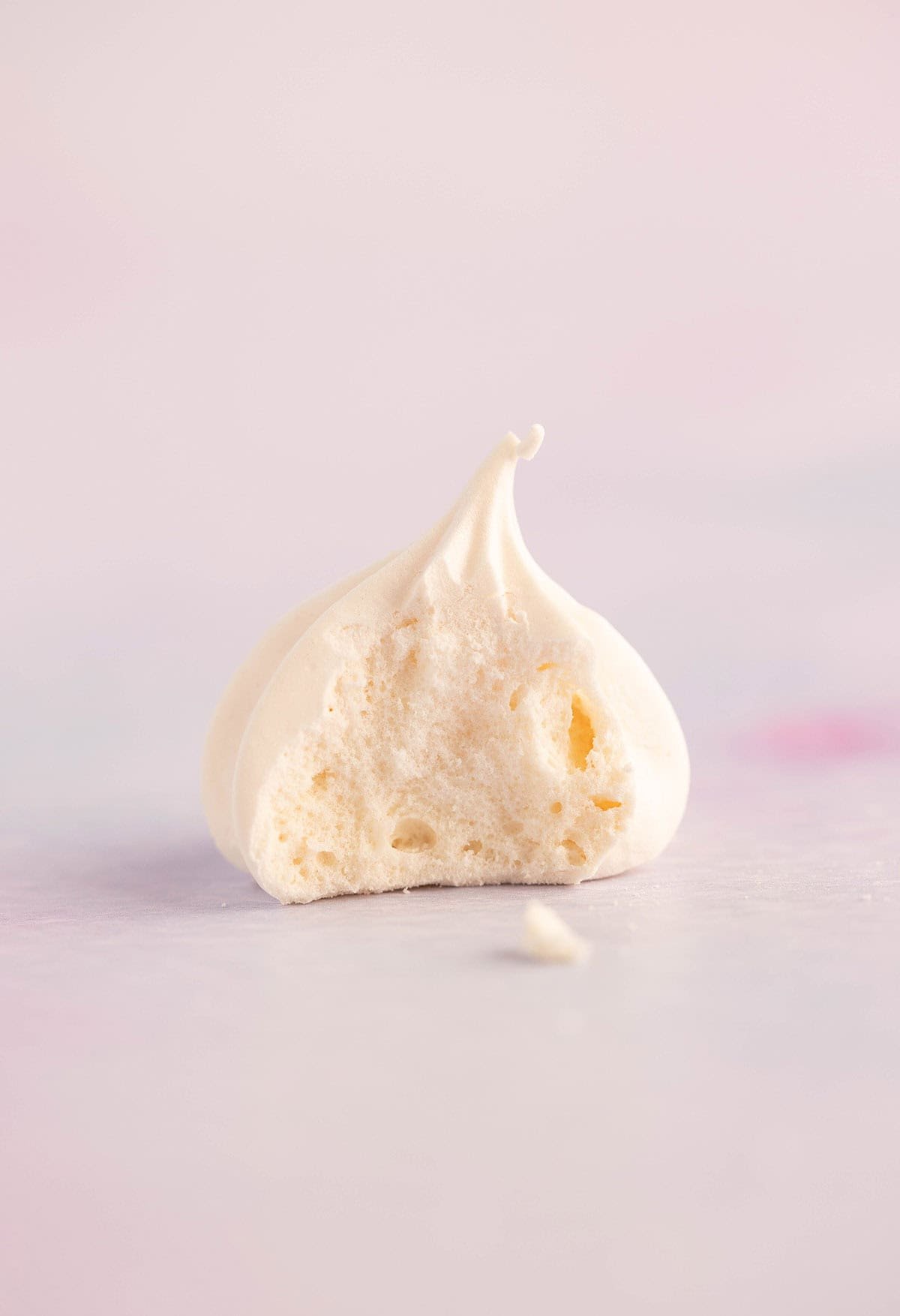 A close up showing the texture inside a meringue kiss cookie.