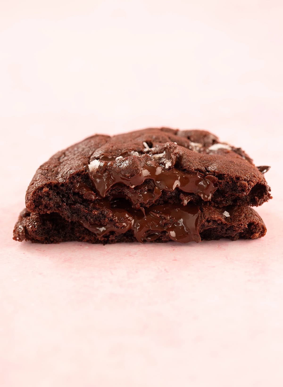 A Single Serve Chocolate Cookie broken in half to show the fudgy middle.