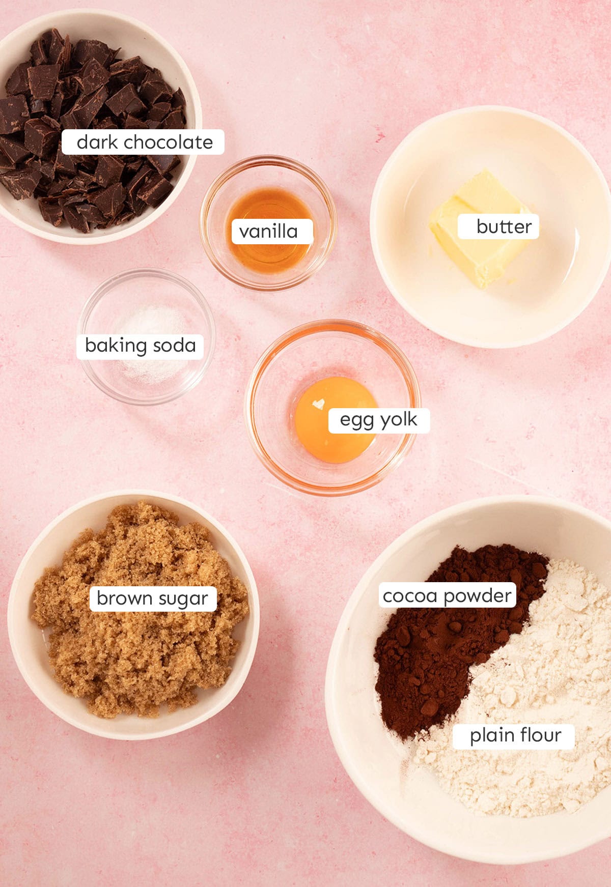 All the ingredients needed to make Single Serve Chocolate Cookies laid out on a pink backdrop.