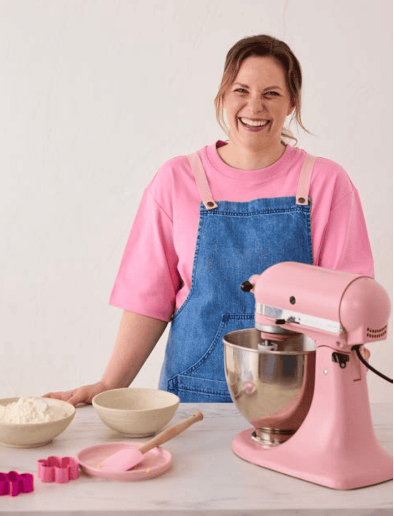 Jessica Holmes in a blue apron in her kitchen