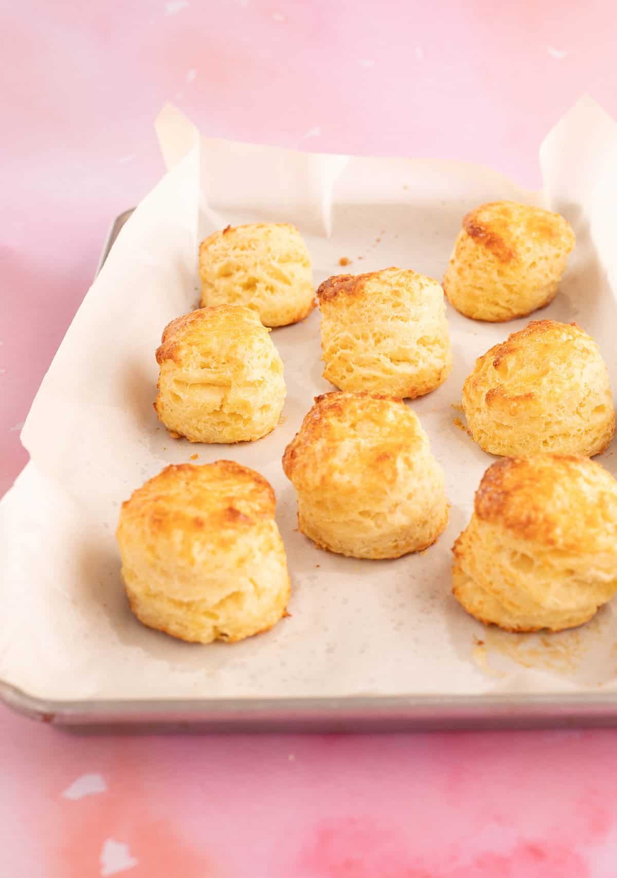 A baking tray of lovely homemade cheese scones fresh out of the oven.