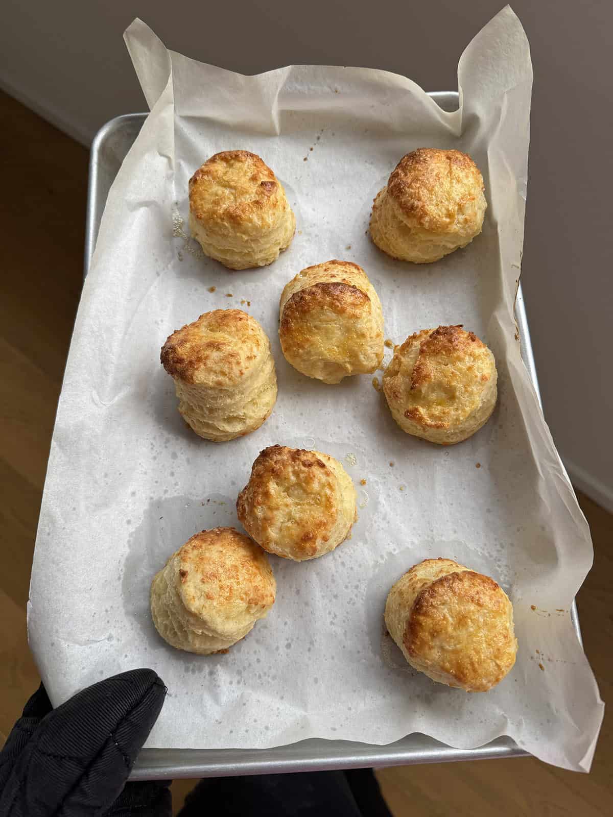 Jessica Holmes holding a tray of cheese scones she has made.