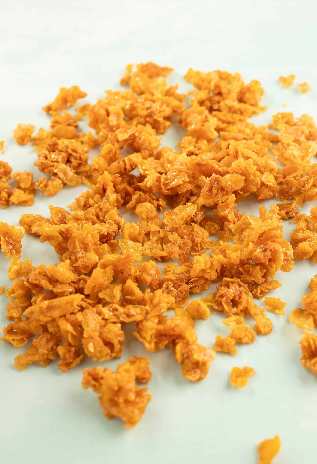 Cornflake Crunch scattered out on a green backdrop.
