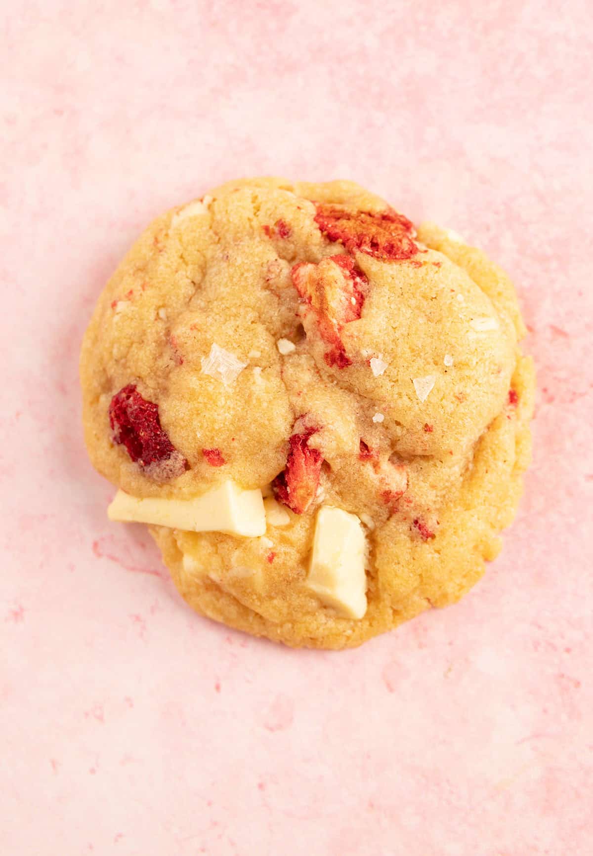 A beautiful Strawberries And Cream Cookies on a pink backdrop. 