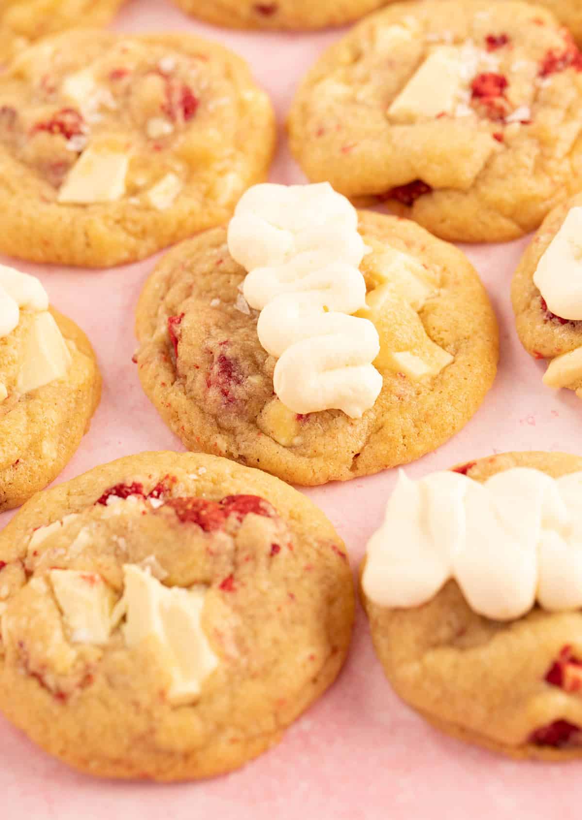 A beautiful group of Strawberry Cookies topped with whipped frosting. 