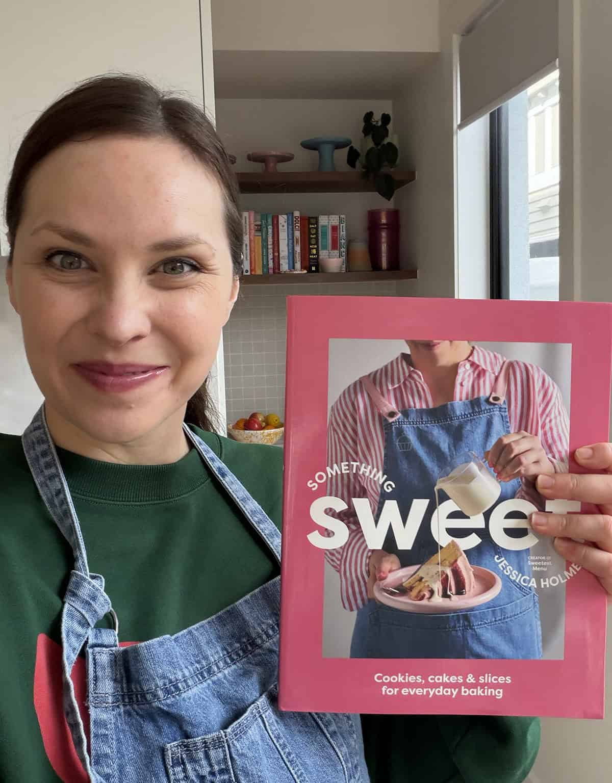 Jessica Holmes holding her book