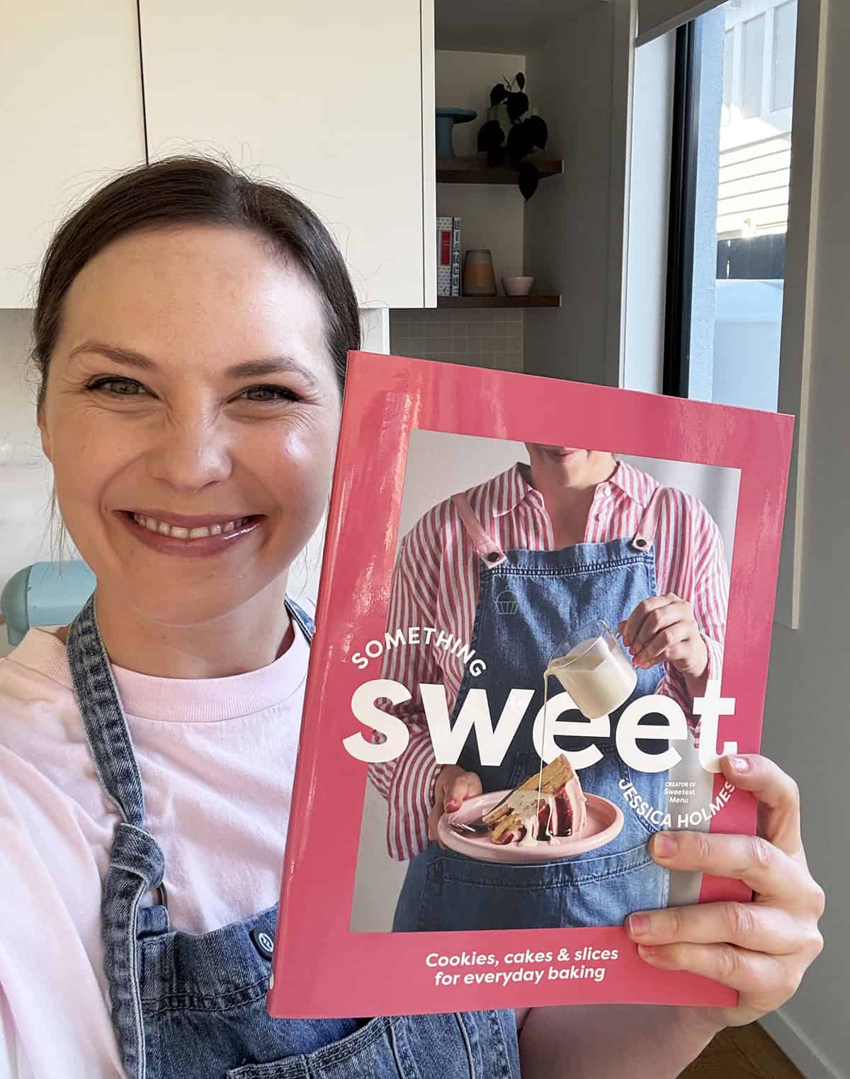 Jessica Holmes holding her book Something Sweet.