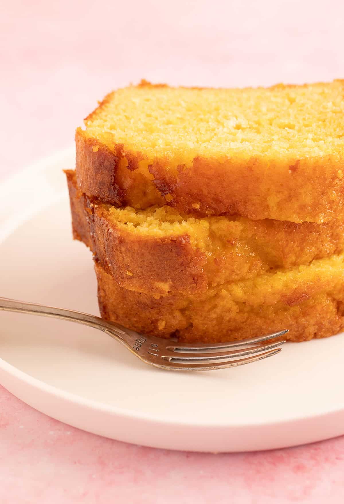 A beautiful stack of Orange Loaf Cake slices.
