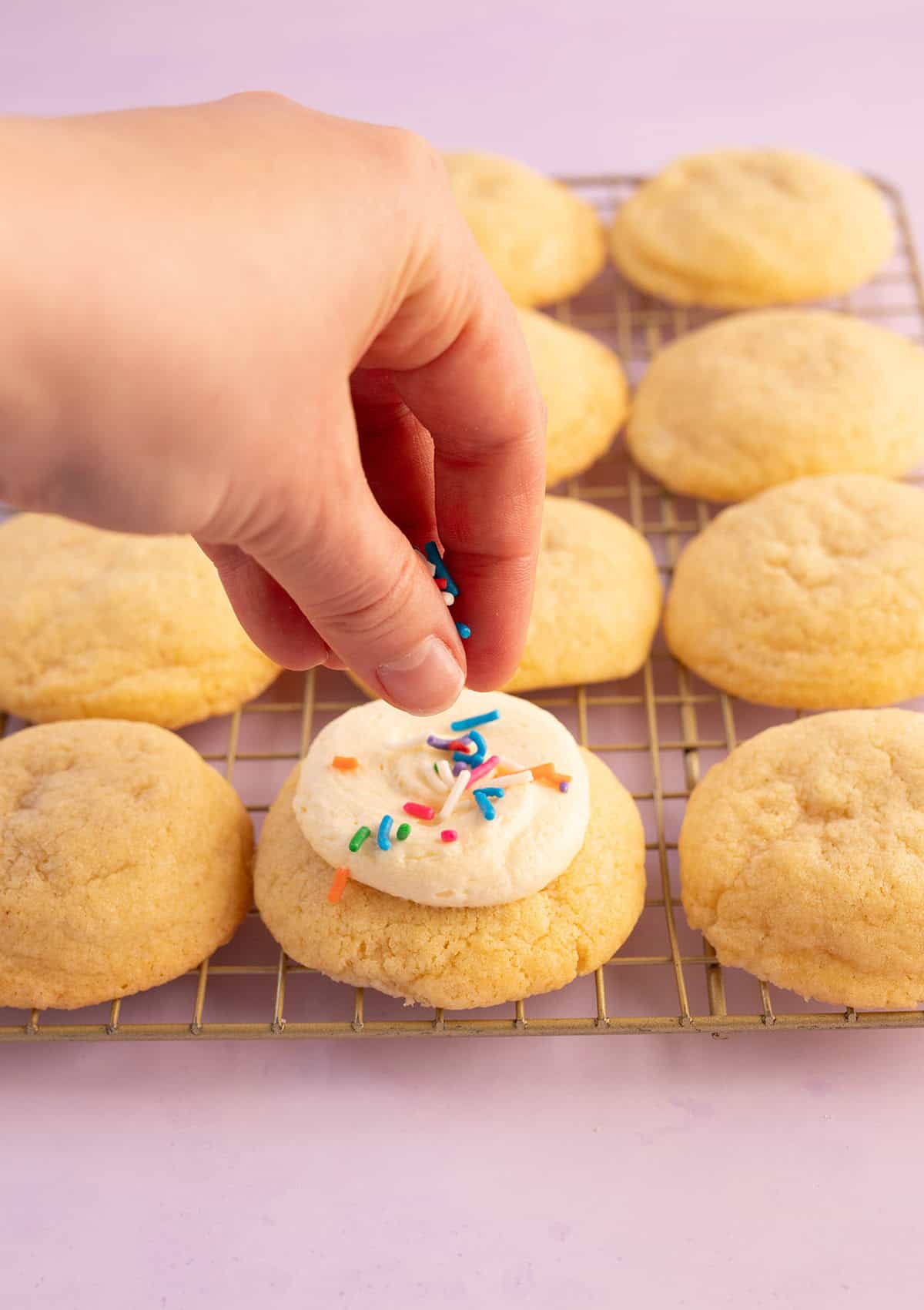 Jessica Holmes' adding sprinkles to her cookies.